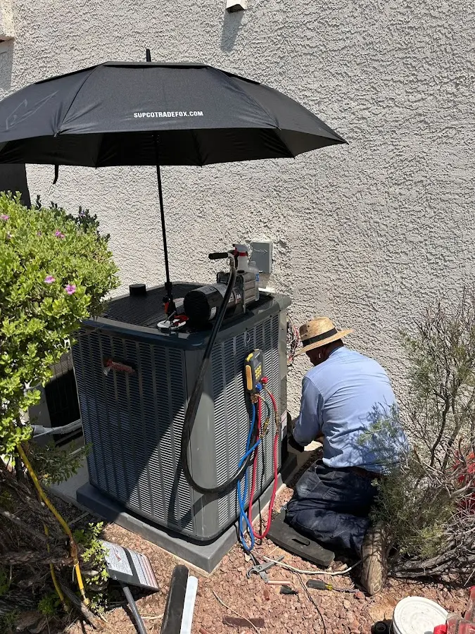 HVAC technician performing outdoor AC maintenance in Heath